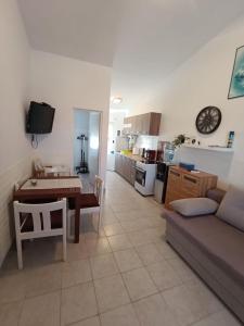 a living room and kitchen with a couch and a table at Apartman Mivela in Vir