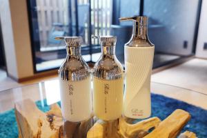 two bottles of wine sitting on a table at OOkami Villa in Omachi