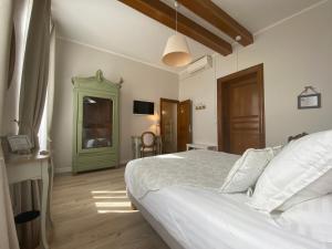 a bedroom with a white bed and a green door at La Maison du Poelon in Labarthe-sur-Lèze +23 photos