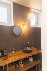 a kitchen with a wooden counter with a sink at l atelier des etoiles in Haybes