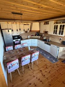 a kitchen with a large wooden table and chairs at Chalupa v prírode in Pliešovce +18 photos