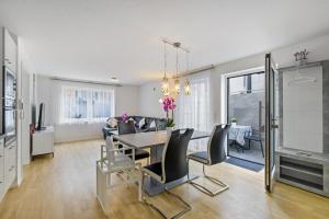 a dining room and living room with a table and chairs at Apartment Dußlingen in Dußlingen
