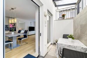 a living room with a table and chairs and a dining room at Apartment Dußlingen in Dußlingen