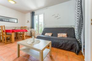 a living room with a couch and a table at Gite les Mazets du Rouret in Saint-Christol-lès-Alès