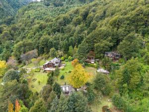 an aerial view of a house in the middle of a mountain at Barraco Lodge in Puelo