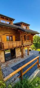 a log cabin with a fence in front of it at DolomitiBel Siberiana 2 SILVER in Braz +17 photos