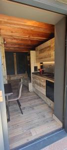 a kitchen with a table and a chair in a room at DolomitiBel Siberiana 2 SILVER in Braz