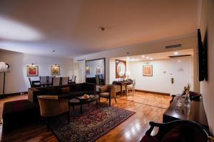 a living room with a couch and a table at Pearl Continental Hotel, Lahore in Lahore
