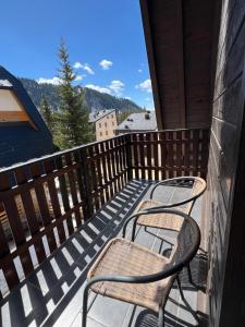 two chairs on a balcony with a view of the mountains at MONTANA in Jahorina