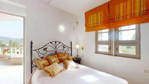 a bedroom with a bed and a window at Epidavros Villas - Elia Garden Retreat with Shared Pool in Nea Epidavros
