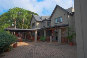 a house with a brick driveway in front of it at Lakeview Cabanas - Unit 5 in St Lucia