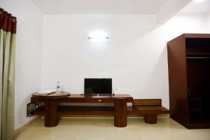 a desk with a computer on it in a room at Luxe By Lotels in Chennai