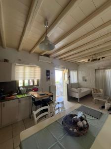 a kitchen and living room with a table at Paros Sunset Villas PSV & PSV2 in Parikia