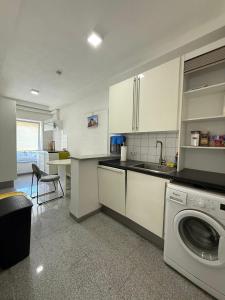 a kitchen with a sink and a washing machine at Team at Home Senden W2 in Senden +15 photos