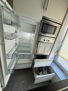 an empty refrigerator with its door open in a room at Team at Home Senden W2 in Senden