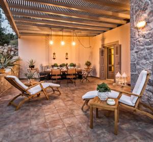a large patio with a table and chairs at Epidavros Villas, Thymari Garden & Seaview Retreat in Nea Epidavros