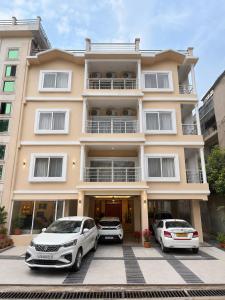two cars parked in front of a building at Vortex Suites in Guwahati