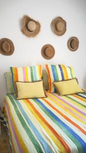 a bedroom with a bed with hats on the wall at La Largarde in Six-Fours-les-Plages