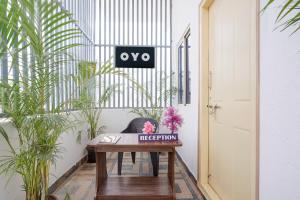 a room with a table and a chair and plants at Hotel O B.N.R. INN in Bangalore +63 photos