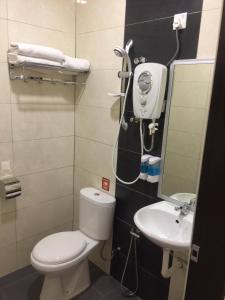 a small bathroom with a toilet and a sink at Hi Star Hotel in Sitiawan