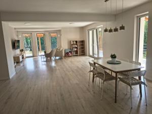 a living room with a dining room table and chairs at Villa Anna in Nowy Targ +35 photos