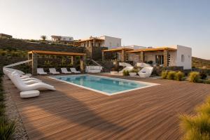a backyard with a swimming pool and a house at Elements Sifnos in Sifnos