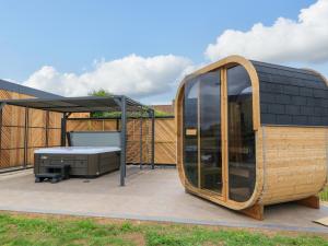 a tiny house with a solarium on a patio at The Cozie Sow in Yeovil