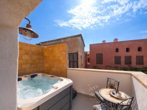a hot tub on the balcony of a building at Jivaeri Luxury Suites in Rhodes Town +71 photos