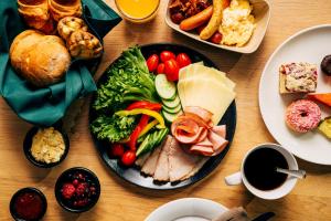a table with a plate of food on a table at Original Sokos Hotel Tapiola Garden Espoo in Espoo