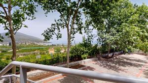 a view from the balcony of a house with trees at Epidavros Villas - Dafni Stone & Garden Retreat in Nea Epidavros