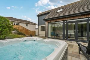 a hot tub in the backyard of a house at Seaddler in Holyhead