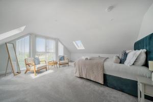 a bedroom with a bed and a table and chairs at Seaddler in Holyhead