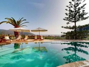 a swimming pool with chairs and umbrellas and a tree at Epidavros Villas Voukamvilia Retreat, Shared Pool in Nea Epidavros