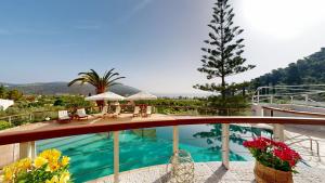 a view of a swimming pool on a house at Epidavros Villas Voukamvilia Retreat, Shared Pool in Nea Epidavros