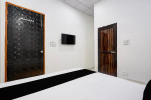 a white room with a bed and a door at Hotel O JIND RESORT in Jīnd +24 photos