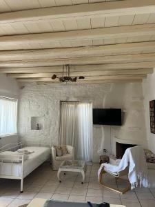 a living room with a bed and a fireplace at Paros Sunset Villas PSV & PSV2 in Parikia