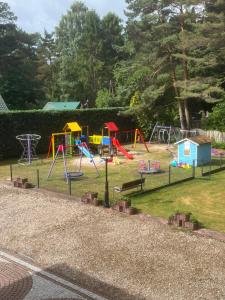 a playground with colorful play equipment in a park at Baracuda in Dębki