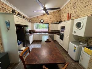 a kitchen with a table and a ceiling fan at Avalon in Arcadia +8 photos