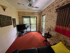 a living room with a couch and a brick wall at Avalon in Arcadia