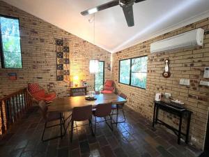 a living room with a wooden table and chairs at Avalon in Arcadia