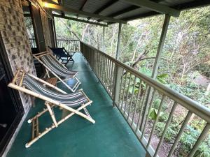 two rocking chairs sitting on a porch at Avalon in Arcadia