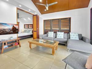 a living room with a couch and a coffee table at Pure Magnetic Villa 9 in Nelly Bay