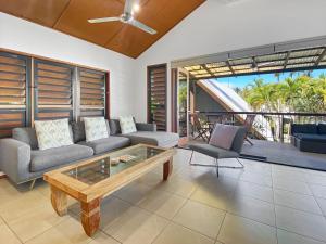 a living room with a couch and a coffee table at Pure Magnetic Villa 9 in Nelly Bay