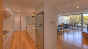 an open kitchen and living room with a dining room at Maggies Beachfront Apartment 8 in Horseshoe Bay +14 photos