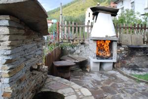 a stone oven with a fire inside of it at Guesthouse KaraIvan in Arda