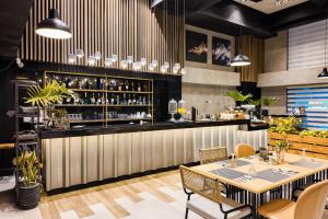 a restaurant with a bar with tables and chairs at JET Hotel Lipa City in Lipa