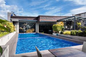 a swimming pool in front of a building at JET Hotel Lipa City in Lipa