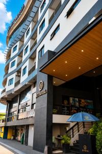 a building with an umbrella in front of it at JET Hotel Lipa City in Lipa