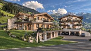 an image of a house with mountains in the background at Grünwaldhof in Tux