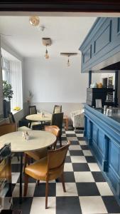 a restaurant with tables and chairs on a checkered floor at The Bognie Inn in Huntly